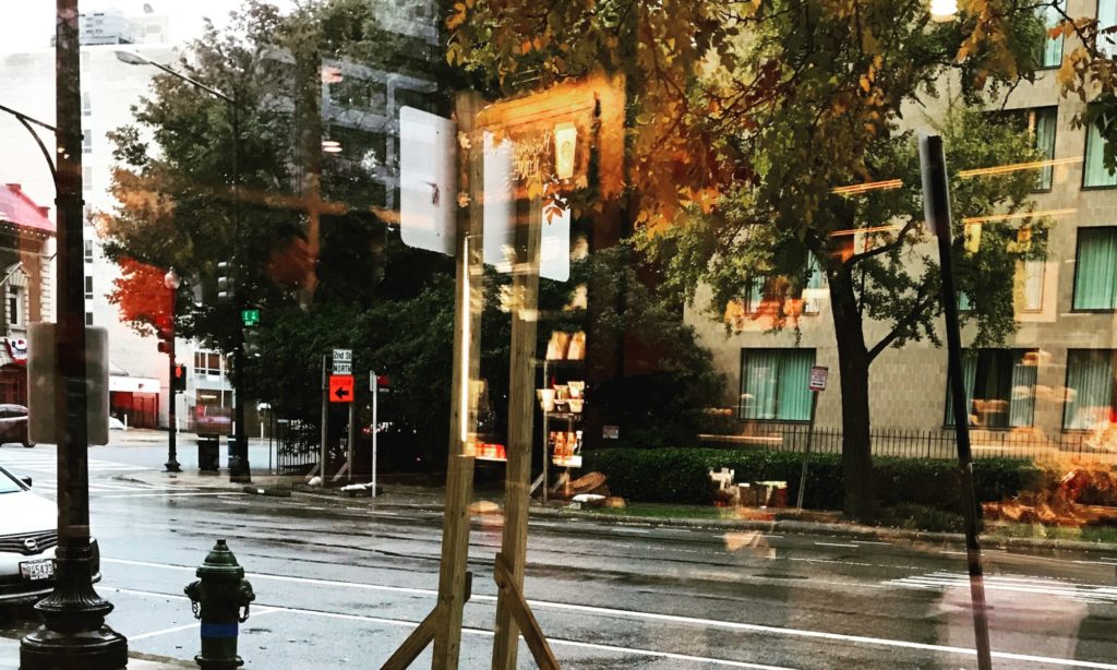 Reflection of a wet street through a coffee shop window